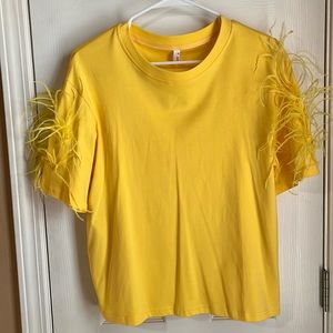 Yellow tee with feathers